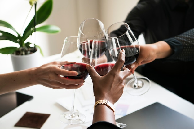 Colleagues toasting wine glasses at work