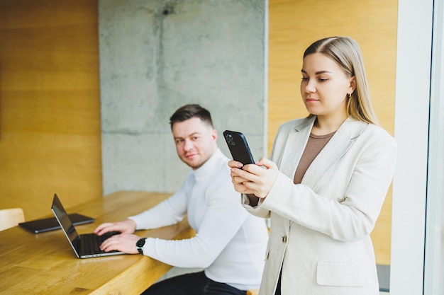 Colleagues while working with a laptop in the office Two goaloriented entrepreneurs collaborate in a modern workspace Two young businessmen work in a bright office