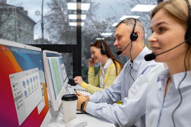 Colleagues working together in a call center with headphones