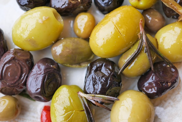 Collection of black and green olives with leaves