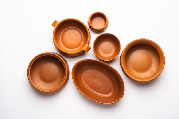 Collection of empty colorful ceramic bowls. Group of utensils captured from above, top view, flat lay against white background