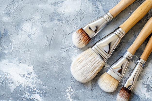 Photo a collection of makeup brushes arranged on a textured gray background