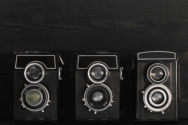 Collection of old film cameras on dark wooden background hobby conceptx9