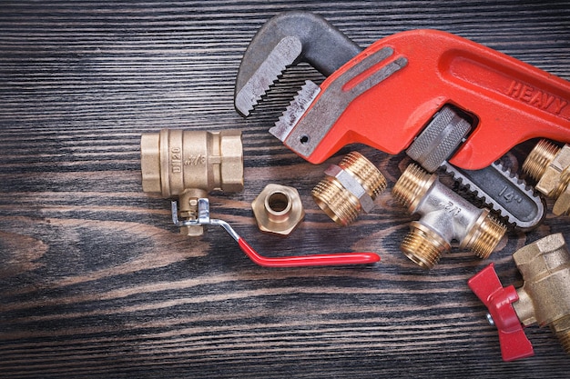 Collection of plumbers equipment on wooden board plumbing concept