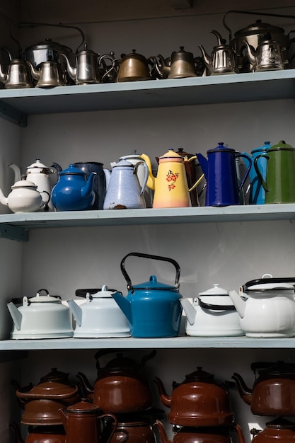 Collection of teapots in museum attracting tourists attention with multicolourness and shapes