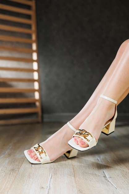 Collection of women's summer shoes Beige leather women's sandals on slender legs and a beige heeled sandal Women's summer elegant sandals