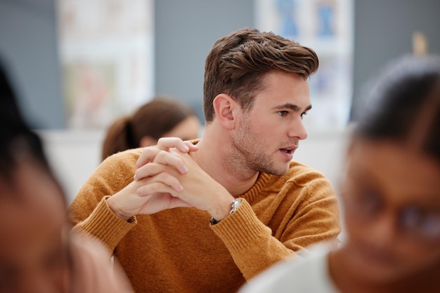 College student and study in a university classroom or lecture for education scholarship and training Thinking male learning and talking in workshop with group of school students in an academy