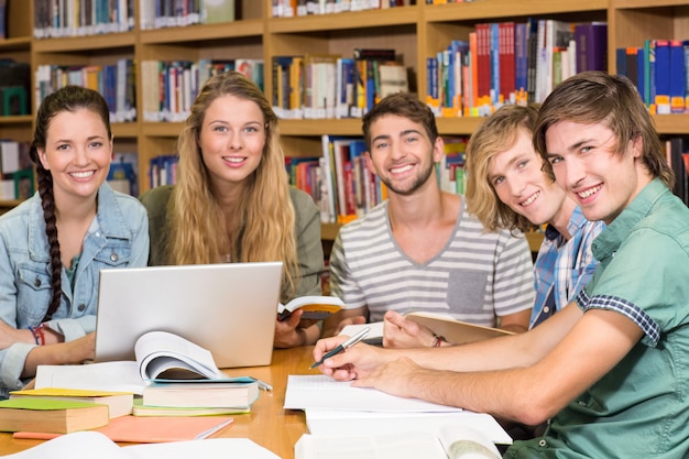 College students doing homework in library