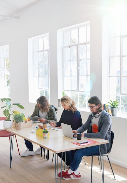 College students sitting at table in class working on project