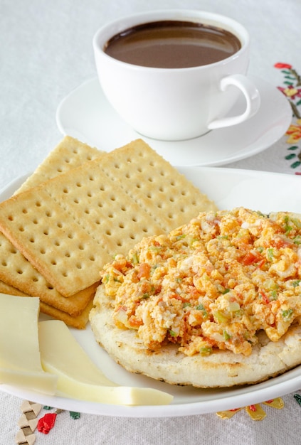 Colombian breakfast Arepa ground corn flour doughegg with traditional sauce called hogado