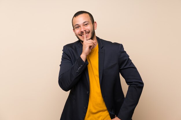 Colombian man over isolated background doing silence gesture