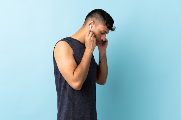 Colombian man listening music isolated