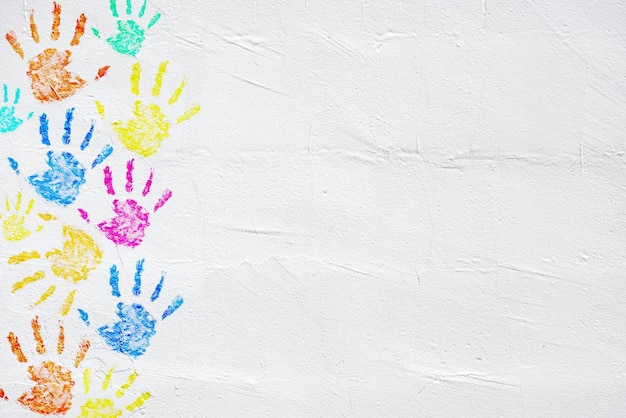 Color hand prints on white wall