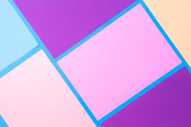 Color papers geometry flat composition background with pink purple violet yellow and blue tones