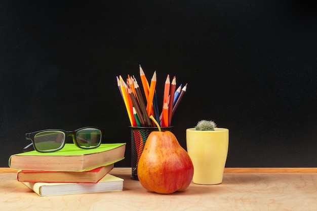 Color pencil in the cup on wooden table