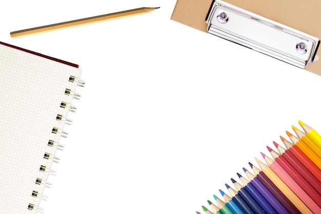 Color pencil with notebook on white background