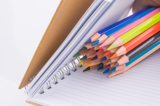 Color pencils of various colors near a notebook