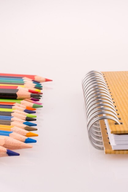 Color pencils of various colors near a notebook