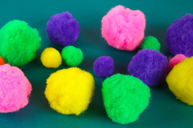 Colored beautiful pompons. Assortment of pompons.