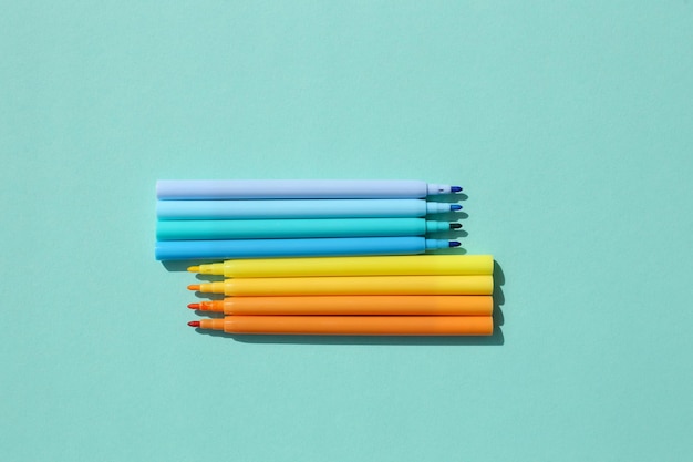 Colored bright stylish felttip pens on a bright colored background