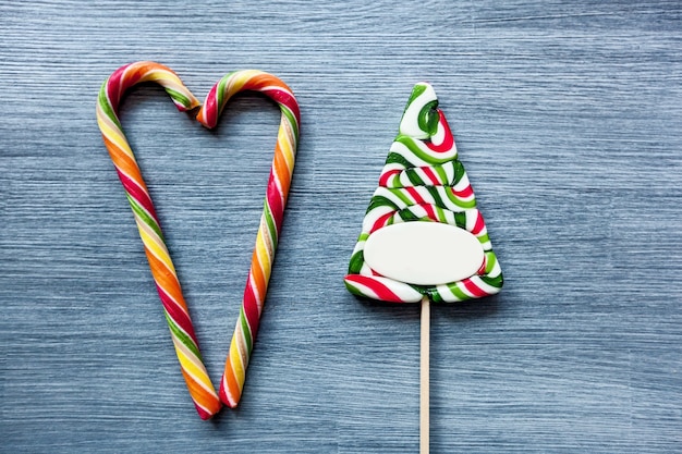 Colored candy lollipops New Years sweets on a blue background Christmas candy canes