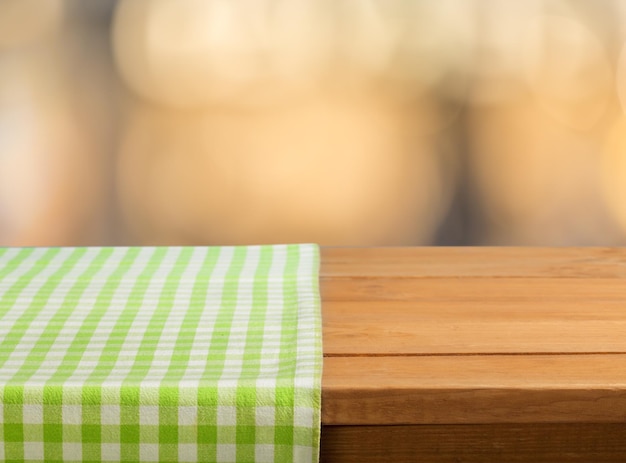 Colored checked tablecloth on wooden table