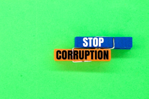 colored clamps with the words Stop corruption the concept of corruption