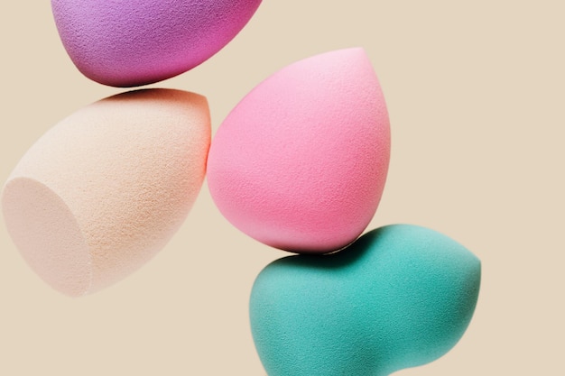 Colored cosmetic beauty blender sponges Green violet pink rainbow colored sponges different shape