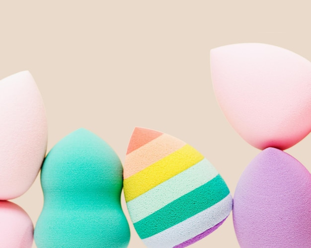 Colored cosmetic beauty blender sponges Green violet pink rainbow colored sponges different shape