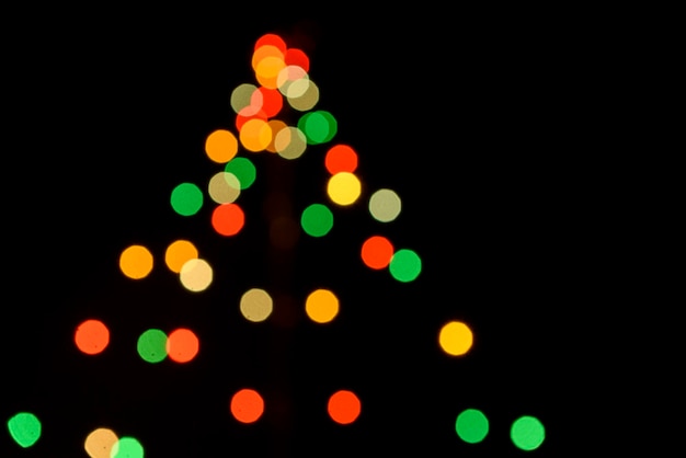 Photo colored defocused lights on dark background. light bokeh.