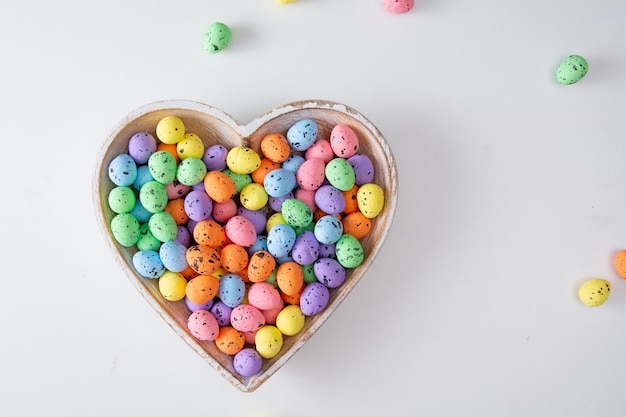 Colored easter eggs in the hearth shape Flat lay minimal holiday concept I love easter