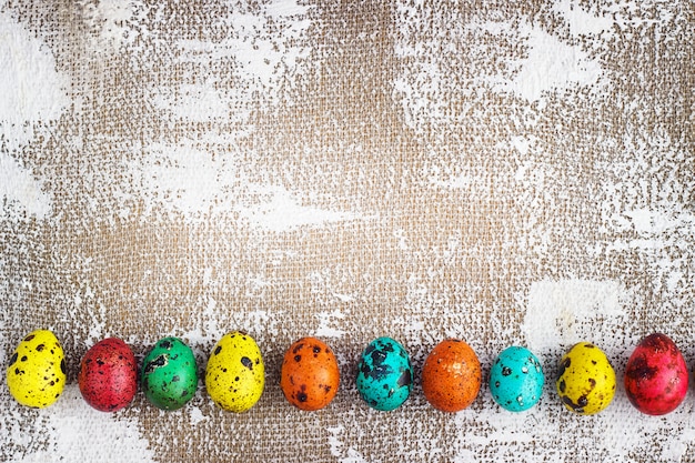 Colored easter eggs on a light canvas background