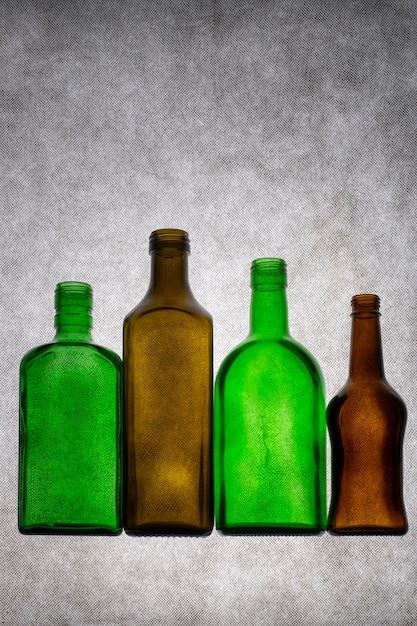 Colored glass bottles on a gray background