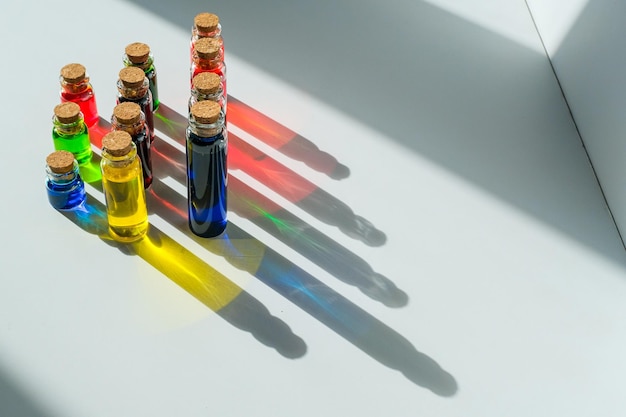 Colored liquids in bottles with stoppers on a white background. Chemicals in test tubes.