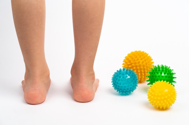 Colored needle balls for massage and physiotherapy on a white background with the image of childrens