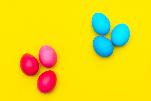 Colored painted eggs on a yellow.