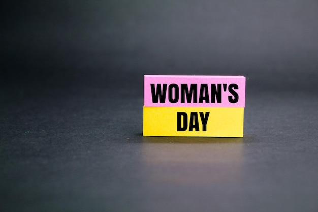 colored paper with the word women's day holiday concept the concept of femininity