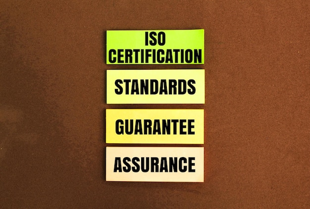 colored paper with the words assurance guarantee standards ISO certification the concept quality