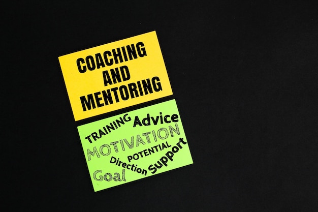 colored paper with the words coaching and mentoring the concept of coaching and mentoring