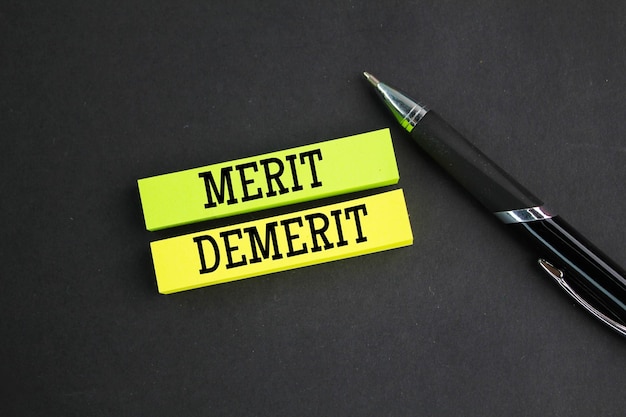 colored paper with the words Merit and Demerit noun a quality deserving blame Merit demerit