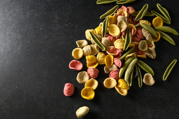 Colored pasta scattered on the table