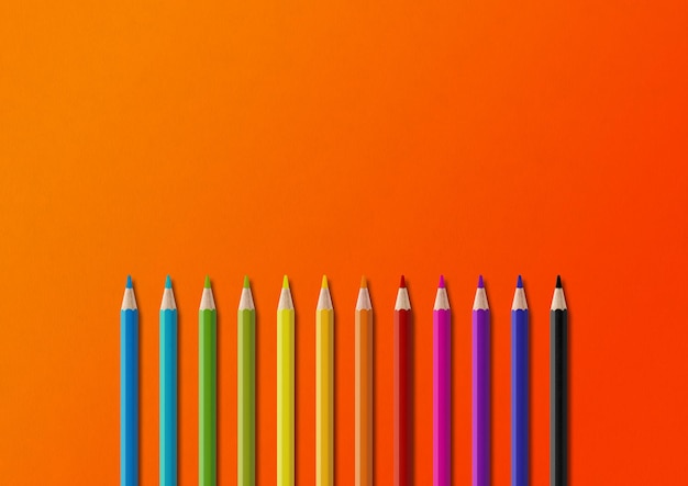 Colored pencil group isolated on orange Horizontal background