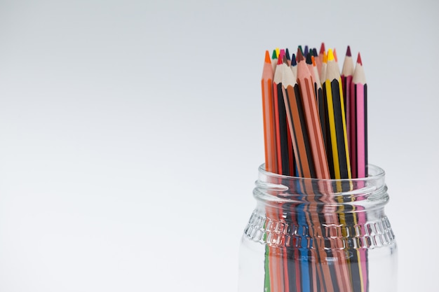 Colored pencils kept in a glass jar