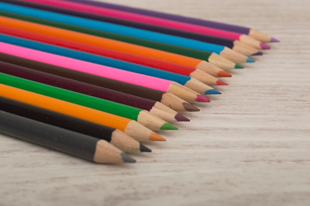 Colored pencils on a wooden table.