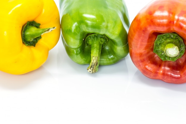 Colored peppers over white background