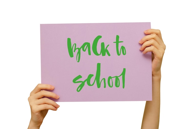 A colored poster in the girl's hand Handwritten inscription Back to school Isolated on white