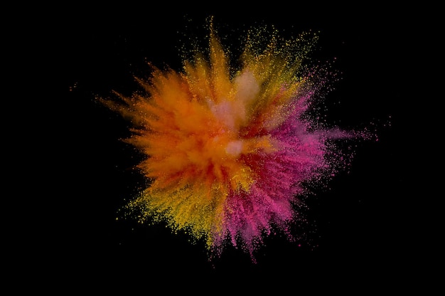 Colored powder explosion. Abstract closeup dust on backdrop. Colorful explode. Paint holi