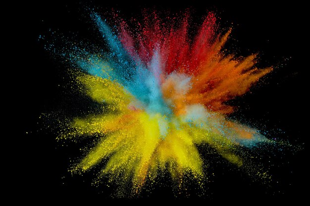 Colored powder explosion. Abstract closeup dust on backdrop. Colorful explode. Paint holi