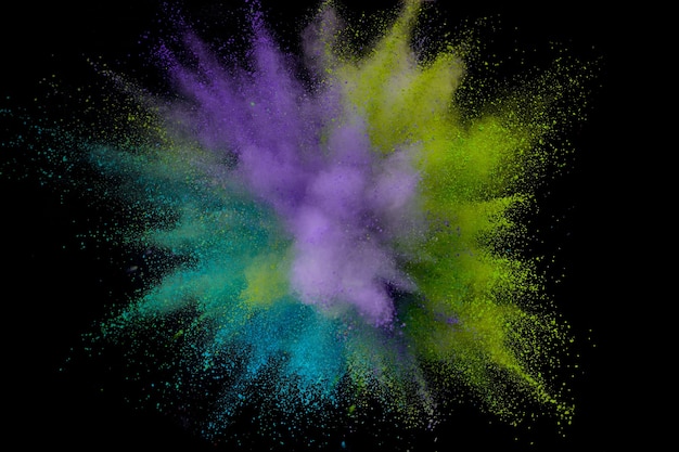 Colored powder explosion. Abstract closeup dust on backdrop. Colorful explode. Paint holi