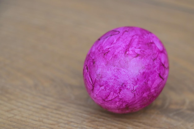 Colored purple egg on the table Preparation for the holiday